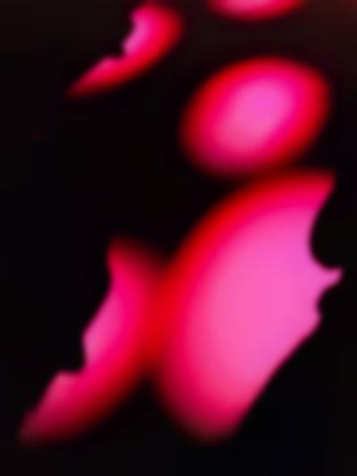 Pink spotlights illuminate a dark surface.