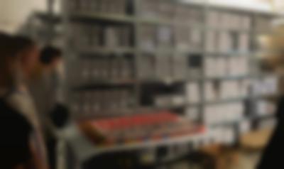 Visit to the (link: https://www.jugendkulturen.de/ text: Archiv der Jugendkulturen target: _blank)[Archive of Youth Cultures], Berlin, 2022. An introduction hosted by workshop participant Daniel Schneider to the extensive collection of zines, leaflets, posters, pins and other printed matter materials from across punk, hip hop, techno genres. Photo: Megan Hoetger.