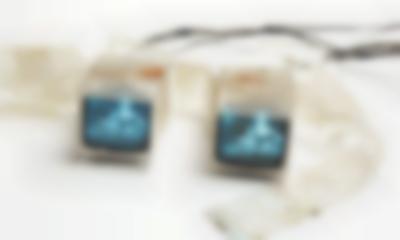 Artistic installation made up of two small TVs connected to each other by a see-through plastic-like material.