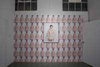 Installation image.  Heather Cassils, *Advertisement (Homage to Benglis)*, 2011. Photograph and Xerox copies; Key art: 30 x 40 inches, and tabloid-sized Xerox: 11 x 17 inches. Key image ©Heather Cassils and Robin Black 2011. Wall installation ©Heather Cassils 2011. Installation photo: Joshua White, courtesy of LACE (Los Angeles Contemporary Exhibitions).