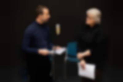 Szymon Adamczak (left) and Sher Doruff (right). Public reading documentation. Grant Watson, *How We Behave / An Archive of Radical Practice*, If I Can't Dance, Amsterdam, December 2023. Photo: Maarten Nauw, courtesy of If I Can't Dance, Amsterdam.