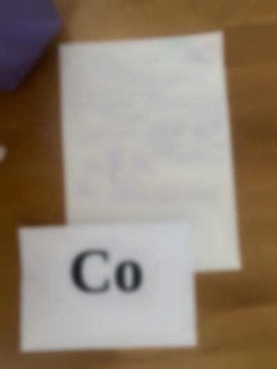 An A4 sheet of paper has been filled with handwritten notes. Slightly on top of it, at the bottom, is another sheet of paper, printed digitally. It says 'Co' in a large font.