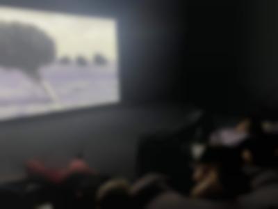 Students watch a film installation in the exhibition *Mountains and Molehills* by Fiona Tan. EYE Filmmuseum, Amsterdam, 2022.