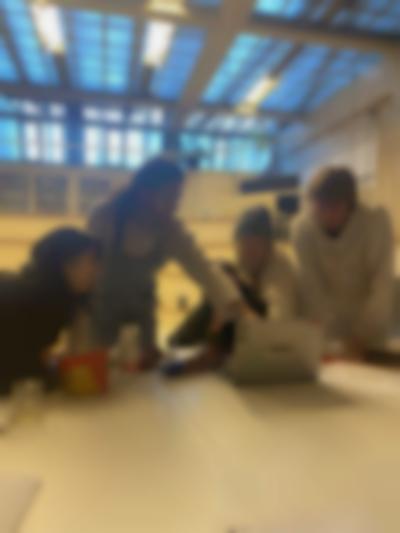 Students gather around the screen in a listening session with ekphrastic texts from *Black Revelry: In Honor of 'The Sugar Shack'* by Derrais Carter (2021). If I Can't Dance, Amsterdam, 2023.