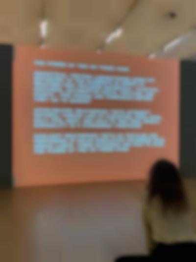 Student watches projection in the exhibition *Bad Color Combos* by Yto Barrada. Stedelijk Museum, Amsterdam, 2022.