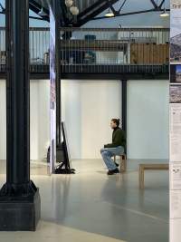Student sits inside the installation *Performing Colonial Toxicity* by Samia Henni. Framer Framed, Amsterdam, 2023.