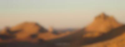 Arid area with sandy hills. A subtitle reads: 