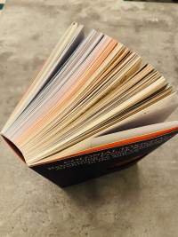 Top edge of book, with pages forming a colour gradient.