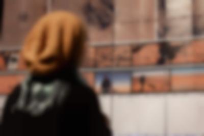 Person looks at a large screen, which has images and text printed on.