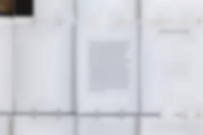 Close-up of a large screen. The installation is made from several A4 sheets attached to each other with metal rings. The title in one of them reads 