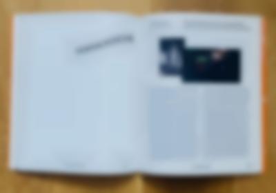 A book lies open. On the top page, 