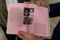 A book is held open, showing a spread with pink pages and four different images with descriptions. The photographs show two stills with the protagonists of Věra Chytilová's film 